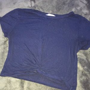 Navy blue shirt with a tied knot.